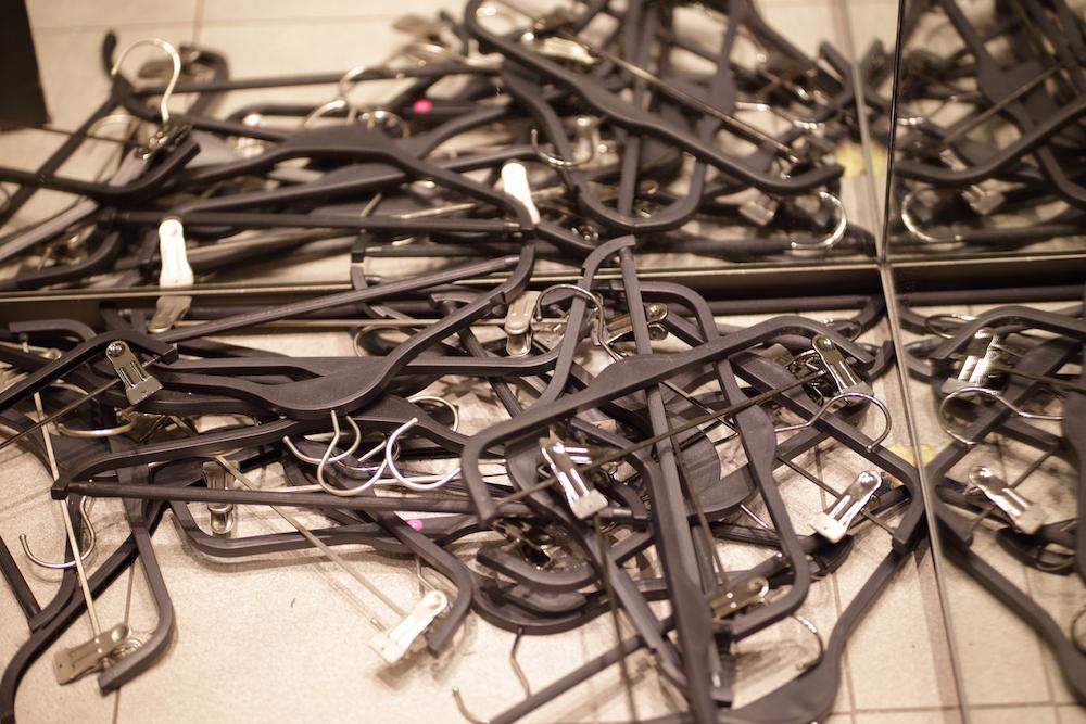 A pile of black plastic garment hangers