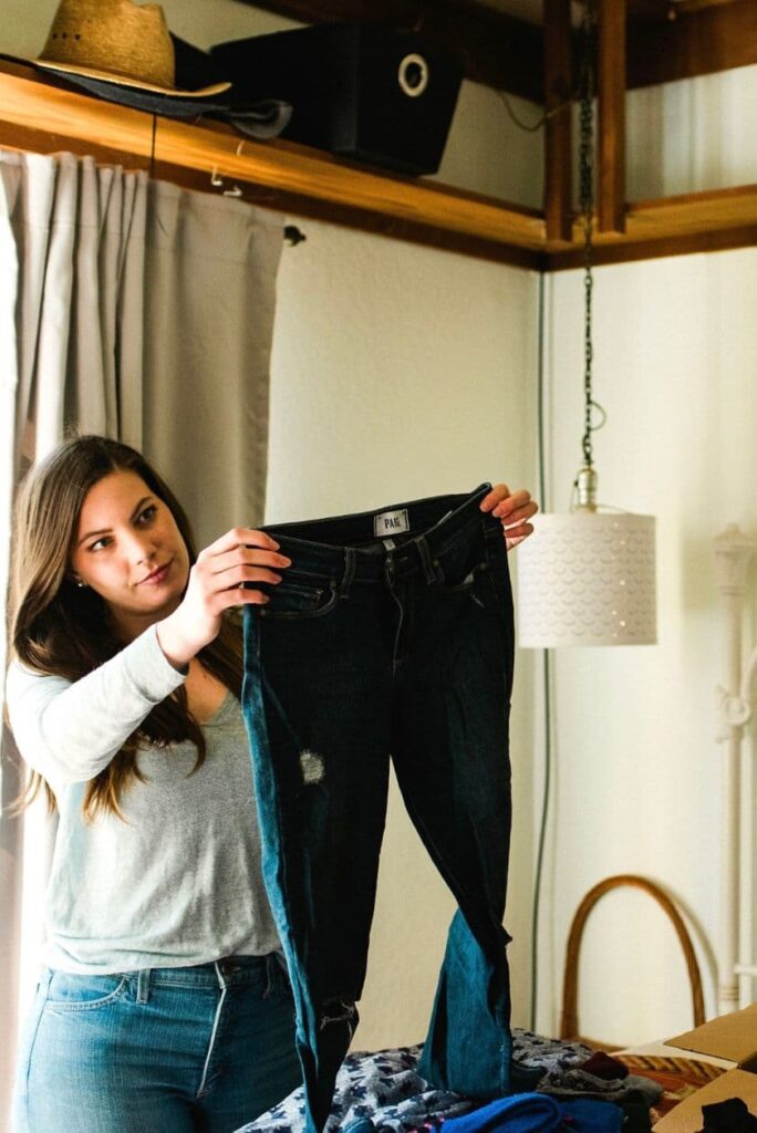 woman holding jeans